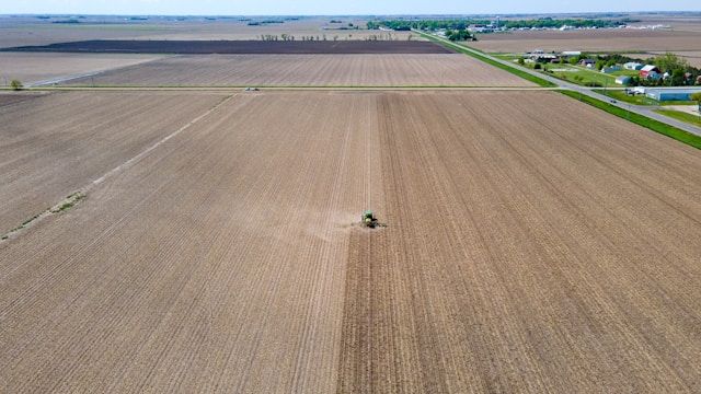 an overhead shot of a tractor plowing fields