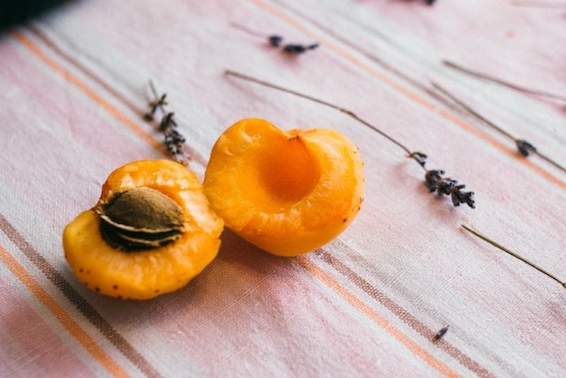 an apricot open on a table showing seed