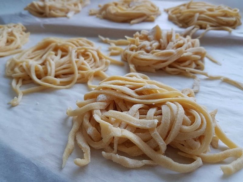 several piles of rolled up uncooked pasta