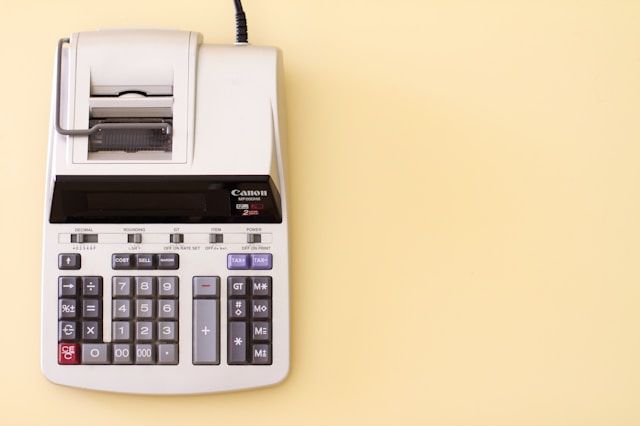 an accountants calculator on a yellow background