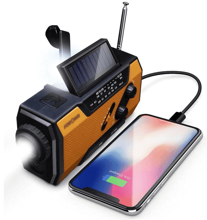A yellow and black emergency radio with its flashlight on and a smartphone plugged in